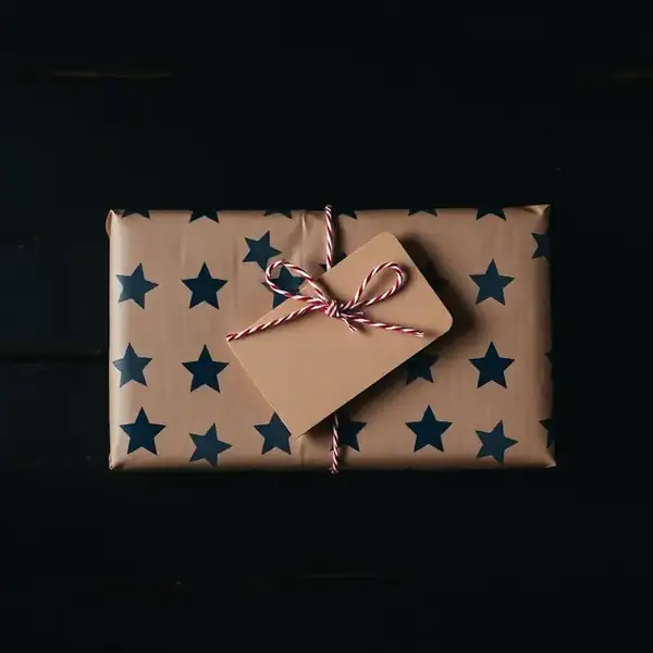 Gift wrapped in star patterned paper with a kraft tag
